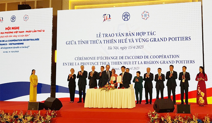Vice Permanent Chairman Nguyen Thanh Binh and the leader of Grand Poitiers urban community (France) sign and hand over the cooperation agreement.