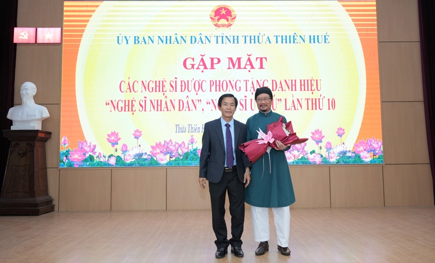Chủ tịch UBND tỉnh Nguyễn Văn Phương tặng hoa chúc mừng NSND Nguyễn Đình Dũng, nguyên Phó Giám đốc phụ trách Nhà hát Nghệ thuật ca kịch Huế