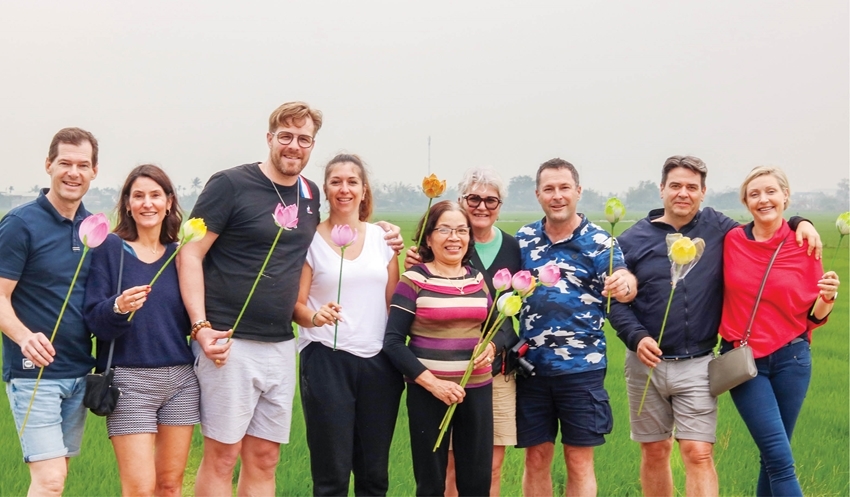 International tourists and Thanh Tien paper flowers. Photo: Slow Travel Hue