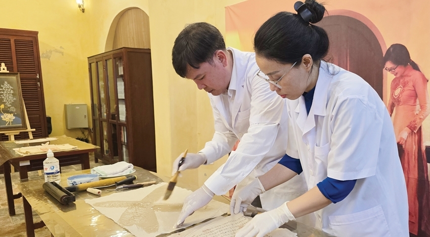 Staff of the Scientific Research Division restoring and conserving historical documents at Tang Tho Pavilion